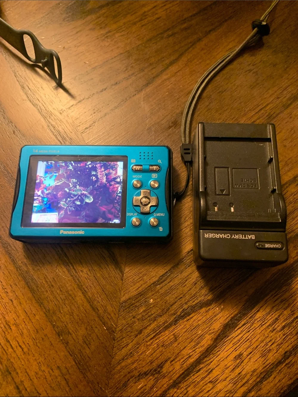 Panasonic Lumix compact camera in bright blue with black charger